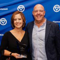 Joyce Ohm smiles with her award next to her husband